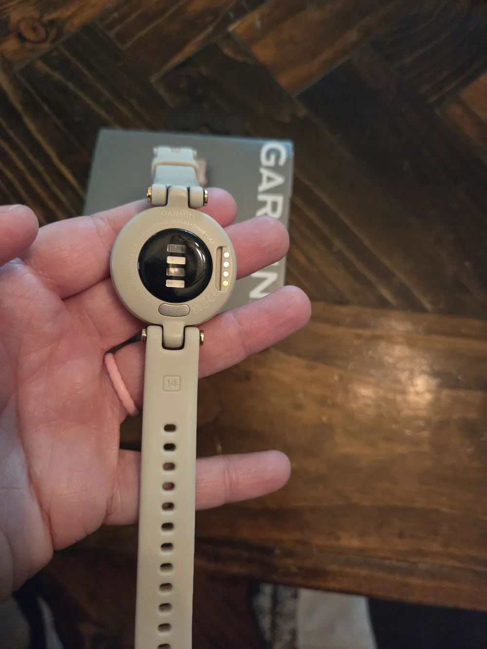 garmin beige smartwatch with rose gold